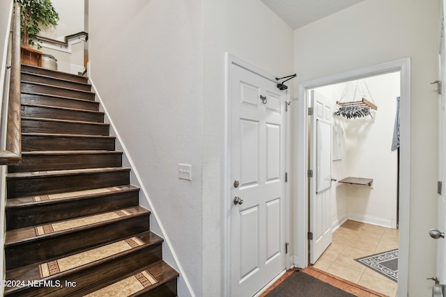 stairs featuring tile patterned flooring