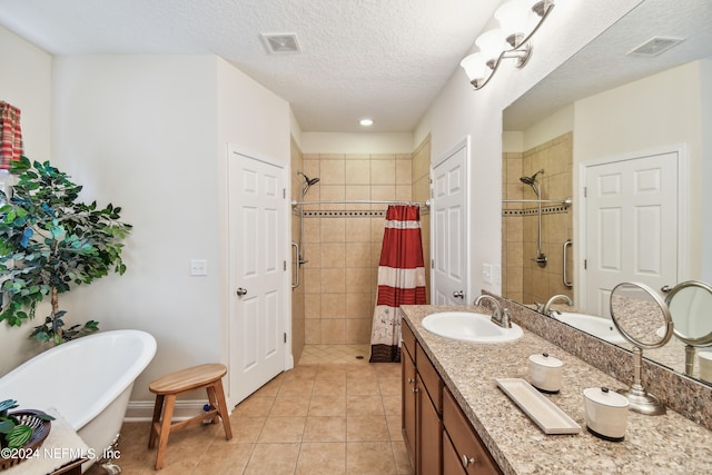 bathroom featuring tile patterned flooring, vanity, a textured ceiling, and separate shower and tub