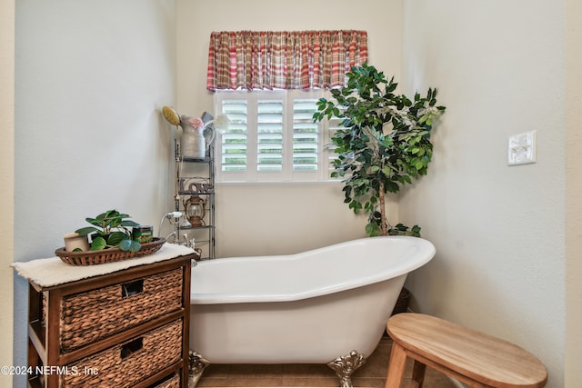 bathroom with tile patterned floors and a washtub