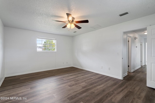 spare room featuring a textured ceiling, ceiling fan, and dark hardwood / wood-style flooring