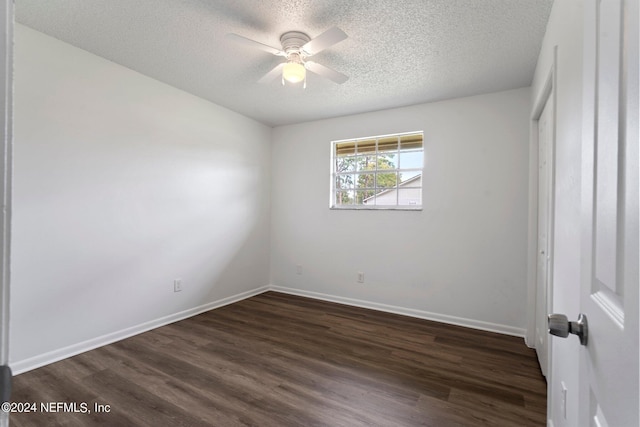 unfurnished bedroom with dark wood-style floors, baseboards, ceiling fan, and a textured ceiling