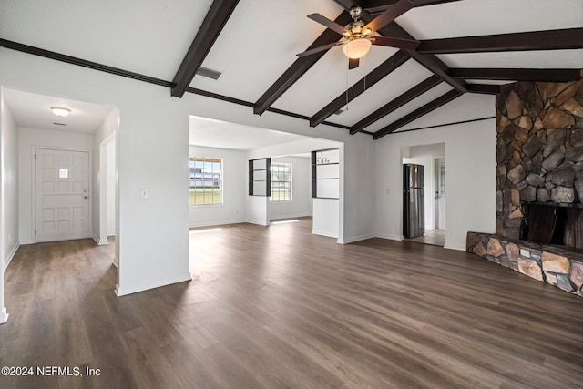 unfurnished living room featuring vaulted ceiling with beams, a fireplace, ceiling fan, and dark wood-type flooring