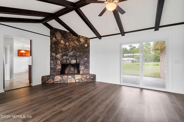 unfurnished living room featuring vaulted ceiling with beams, wood-type flooring, a fireplace, and ceiling fan