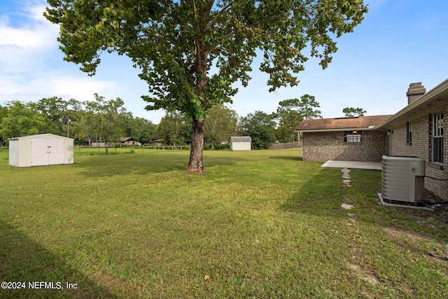 view of yard featuring a storage shed and cooling unit