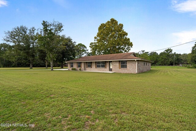 single story home featuring a front lawn and brick siding