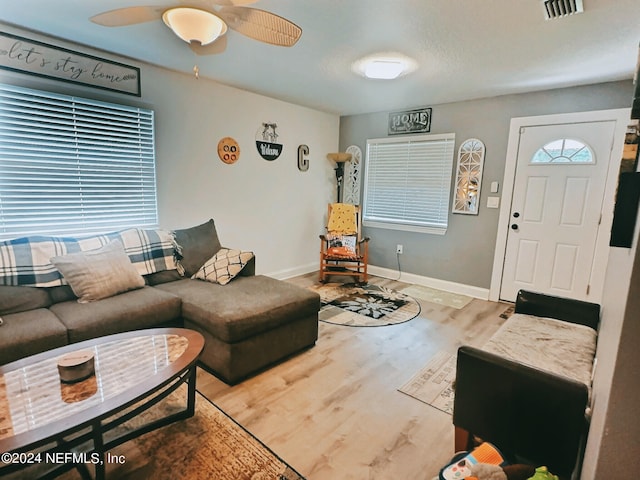 living room featuring ceiling fan and hardwood / wood-style floors