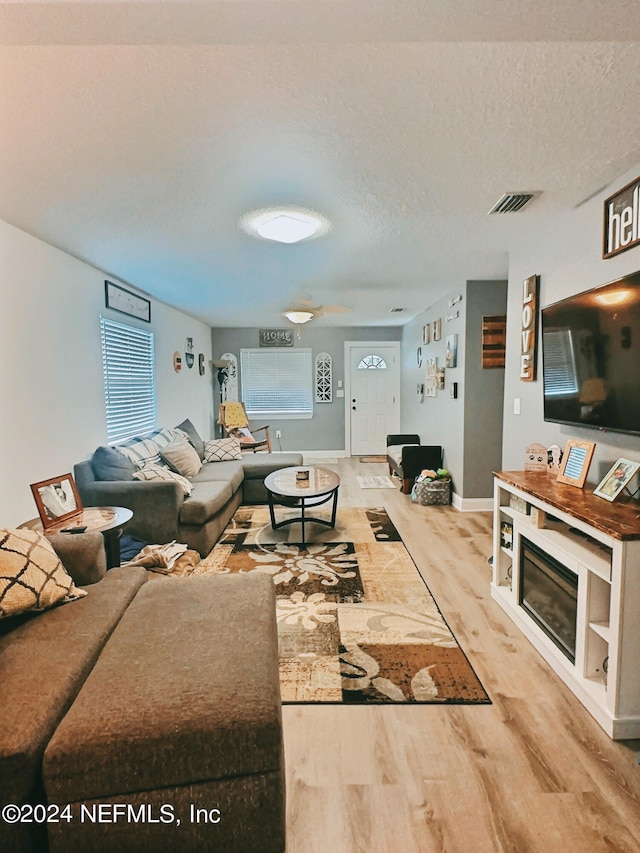 living room featuring a textured ceiling and hardwood / wood-style floors