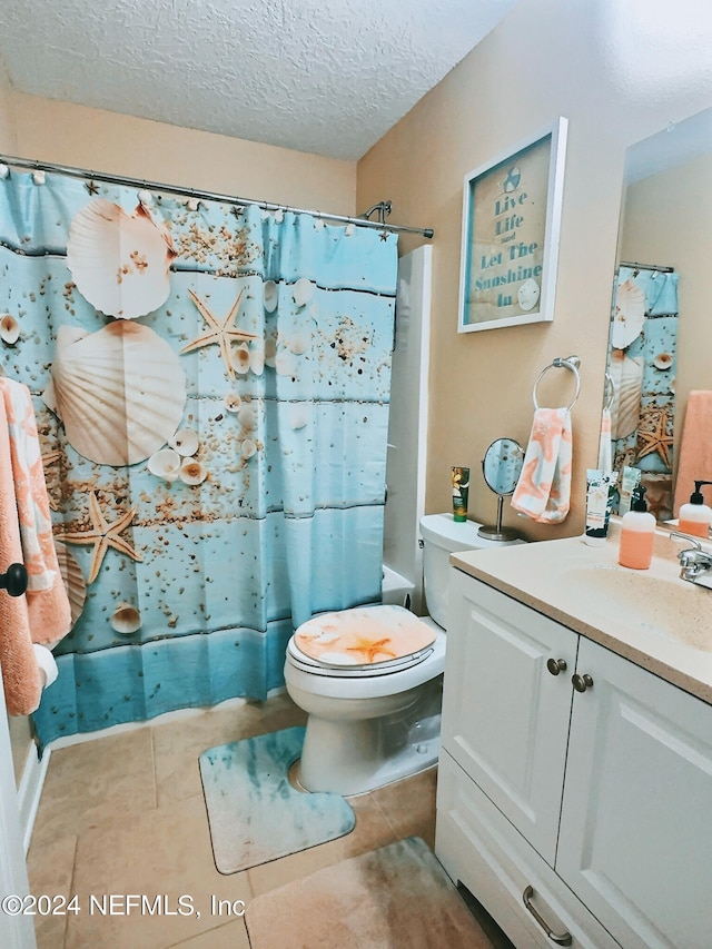 full bathroom with tile patterned flooring, a textured ceiling, shower / tub combo, vanity, and toilet