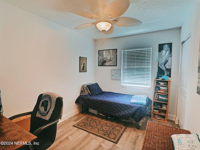 bedroom with ceiling fan and light wood-type flooring