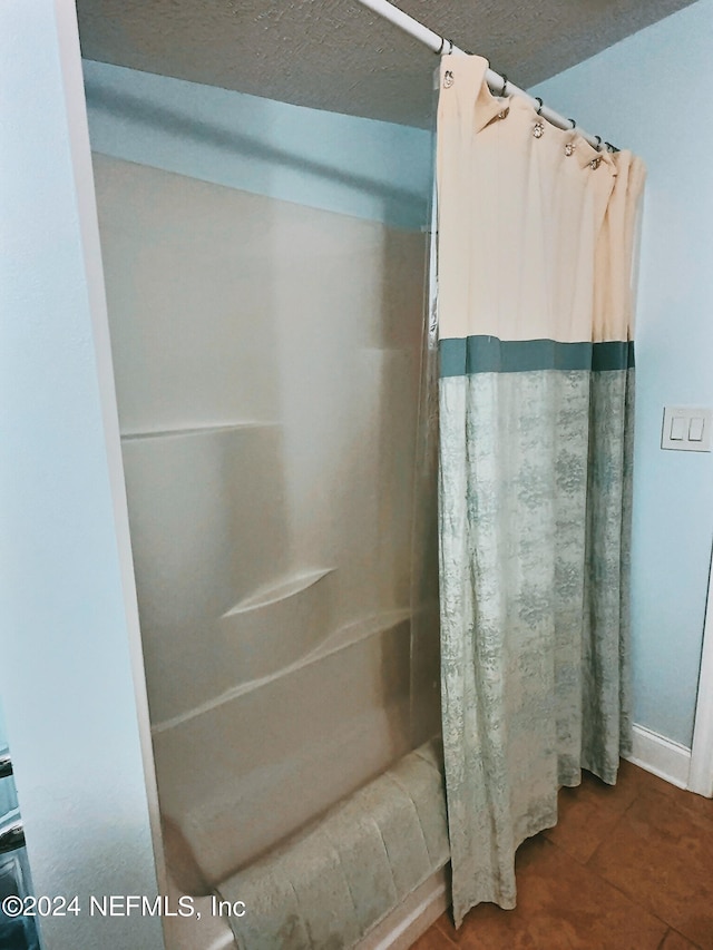 bathroom featuring tile patterned flooring and curtained shower