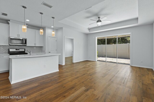 kitchen featuring ceiling fan, white cabinets, black electric range, a center island with sink, and dark wood-type flooring