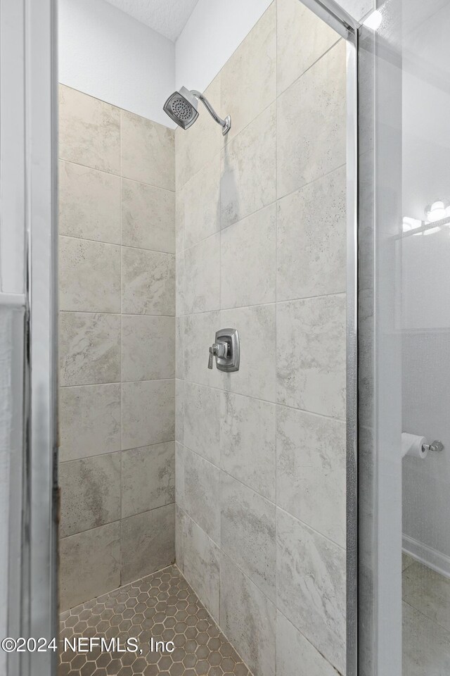 bathroom with a tile shower