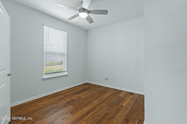 empty room with ceiling fan and dark wood-type flooring