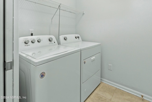 laundry room with light tile patterned floors and independent washer and dryer