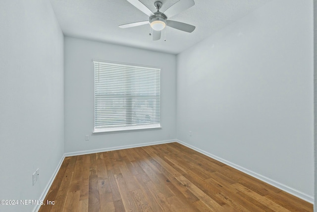 unfurnished room with a textured ceiling, wood-type flooring, and ceiling fan