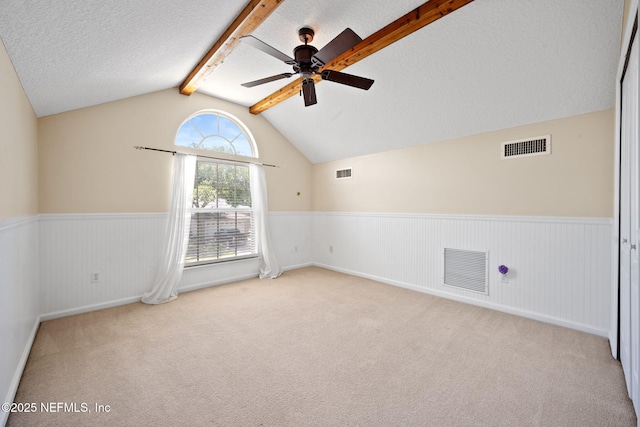 96316 Ridgewood Cir, Fernandina Beach, FL 32034 - empty room with wainscoting, a ceiling fan, a textured ceiling, and carpet