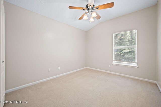 96316 Ridgewood Cir, Fernandina Beach, FL 32034 - spare room featuring carpet, baseboards, vaulted ceiling, and ceiling fan