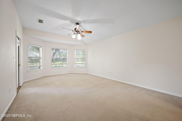 96316 Ridgewood Cir, Fernandina Beach, FL 32034 - spare room featuring light colored carpet, ceiling fan, baseboards, and a textured ceiling