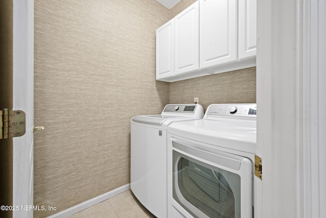 96316 Ridgewood Cir, Fernandina Beach, FL 32034 - laundry room featuring washing machine and dryer, light tile patterned floors, and cabinet space