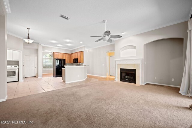 96316 Ridgewood Cir, Fernandina Beach, FL 32034 - unfurnished living room with arched walkways, washer / clothes dryer, crown molding, light colored carpet, and baseboards