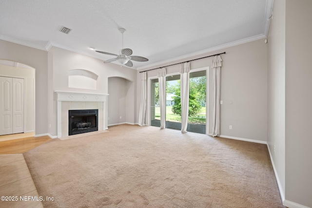 96316 Ridgewood Cir, Fernandina Beach, FL 32034 - unfurnished living room featuring crown molding, a ceiling fan, a fireplace, baseboards, and carpet flooring