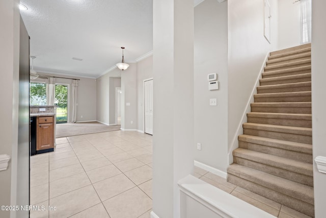 96316 Ridgewood Cir, Fernandina Beach, FL 32034 - stairway featuring tile patterned flooring, crown molding, and baseboards