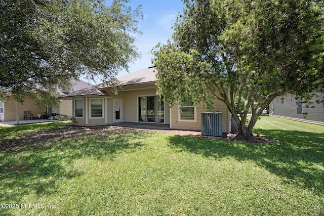 96316 Ridgewood Cir, Fernandina Beach, FL 32034 - back of property with cooling unit, a patio area, and a lawn