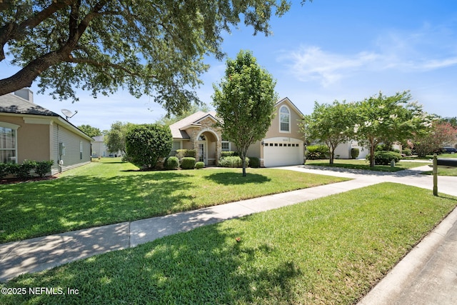 96316 Ridgewood Cir, Fernandina Beach, FL 32034 - obstructed view of property featuring an attached garage, a front lawn, concrete driveway, and stone siding