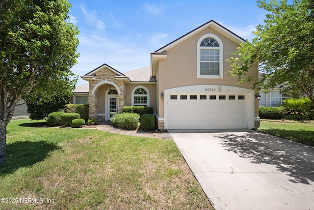 96316 Ridgewood Cir, Fernandina Beach, FL 32034 - traditional home featuring stone siding, stucco siding, a front lawn, driveway, and an attached garage