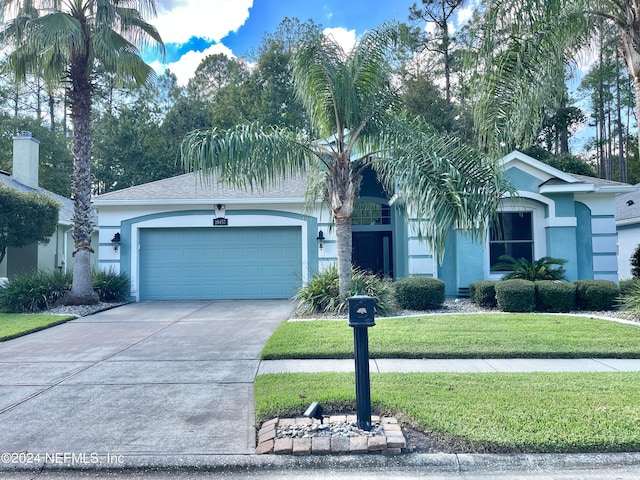 single story home featuring a garage and a front yard