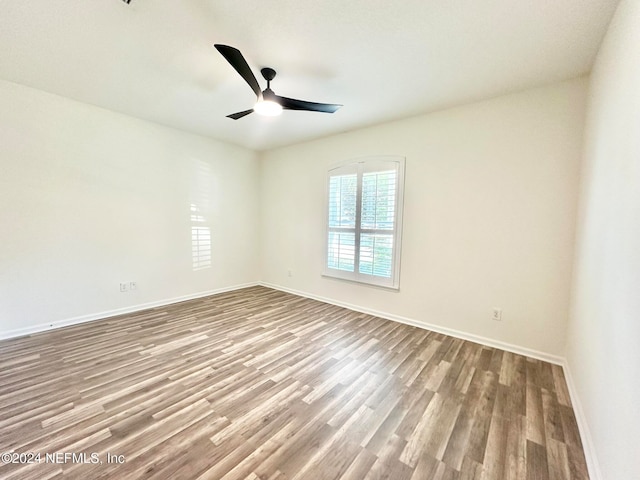 empty room featuring hardwood / wood-style flooring and ceiling fan