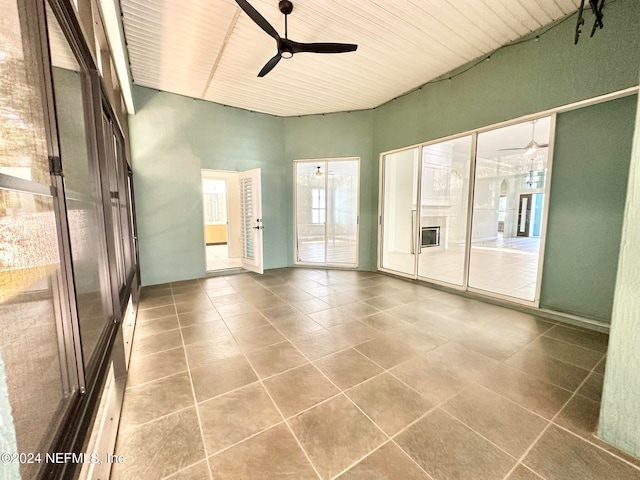 unfurnished room featuring tile patterned floors, ceiling fan, and wooden ceiling