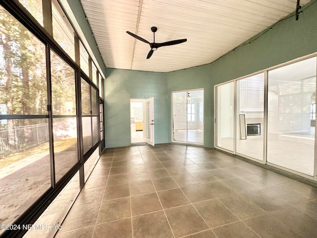 unfurnished sunroom with ceiling fan and wood ceiling