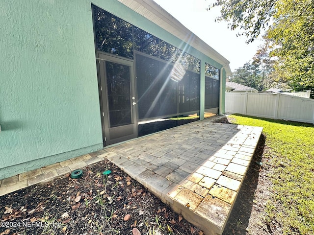 view of patio featuring a sunroom