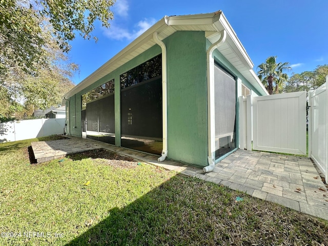 view of property exterior with a lawn