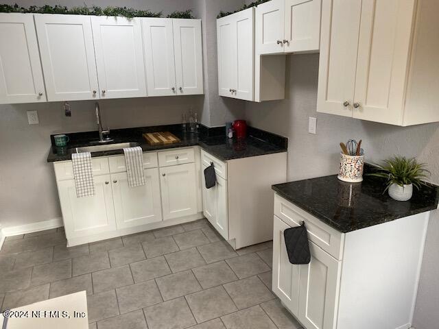 kitchen featuring sink and white cabinetry