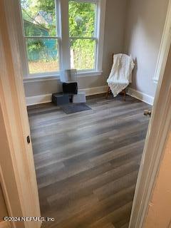 unfurnished room with dark hardwood / wood-style floors