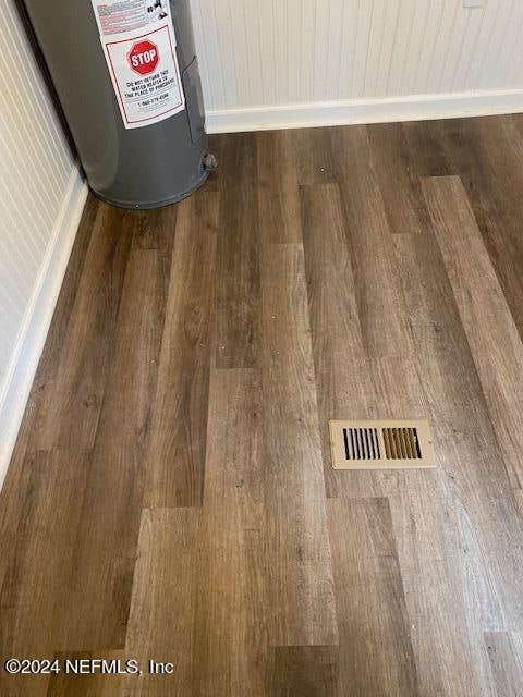 interior details featuring wood-type flooring and water heater