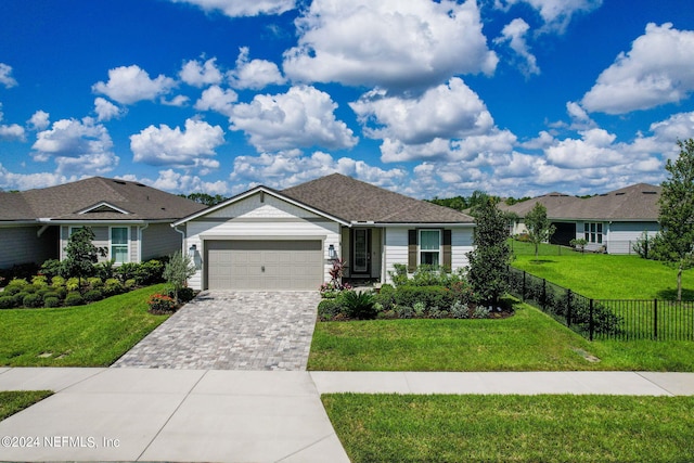 ranch-style house with a garage and a front yard