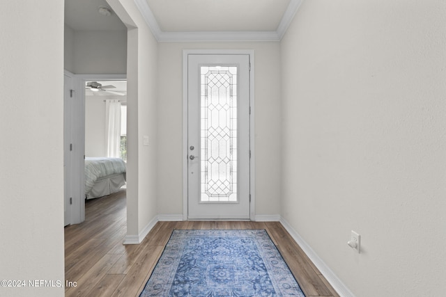 entrance foyer featuring ceiling fan, hardwood / wood-style flooring, and ornamental molding