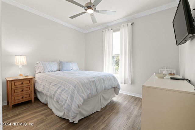 bedroom with wood-type flooring, ceiling fan, and crown molding