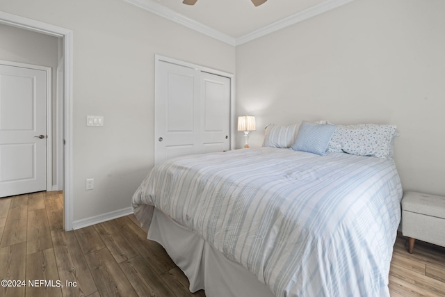 bedroom featuring ornamental molding, ceiling fan, a closet, and hardwood / wood-style floors