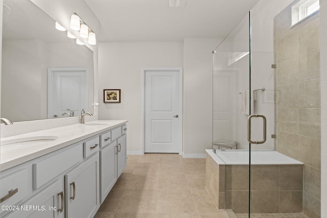 bathroom featuring vanity, shower with separate bathtub, and tile patterned floors