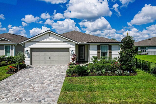 ranch-style house with a garage and a front yard