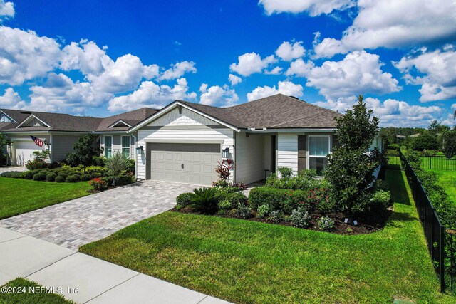 single story home with a garage and a front yard