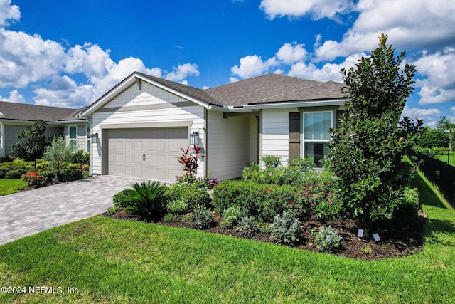 single story home with a front yard and a garage