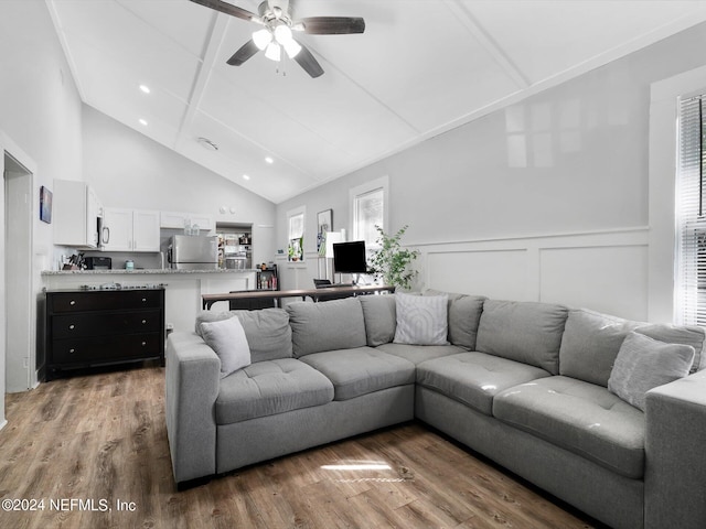 2745 Gilmore St, Jacksonville, FL 32205 - living area with light wood finished floors, beam ceiling, wainscoting, a ceiling fan, and high vaulted ceiling