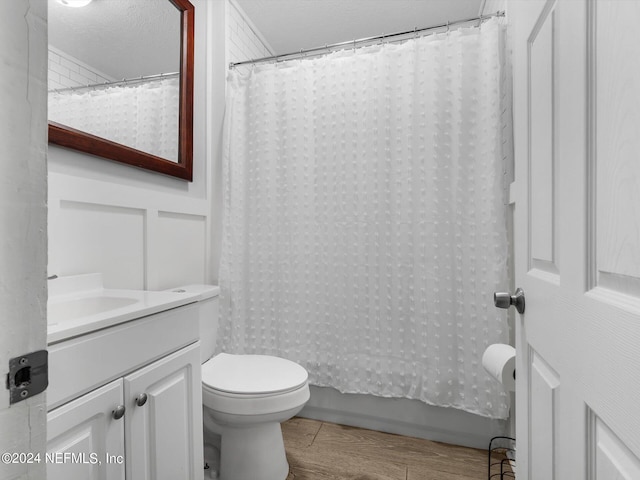2745 Gilmore St, Jacksonville, FL 32205 - full bathroom featuring toilet, vanity, wood finished floors, and shower / bathtub combination with curtain