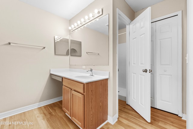 bathroom with wood-type flooring and vanity