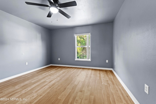 spare room with ceiling fan and light wood-type flooring